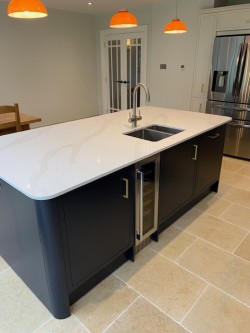 New kitchen extension incorporating central island with quartz worktops & bespoke fridge housing