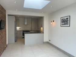 Traditional style kitchen design with a contemporary twist incorporating black mirror chip quartz worktops, porcelain floor tiles & a metro wall tile.